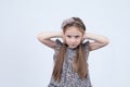 ÃÂ¡ute little girl with long hair not listening. Toddler is covering her closed ears, ignoring her parent
